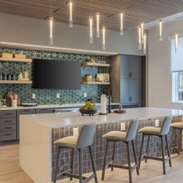 Our resident lounge and kitchen area makes for the perfect hangout spot. Who will you be hanging out with on this stunning space? resident kitchen with island, bar stools, and a tv