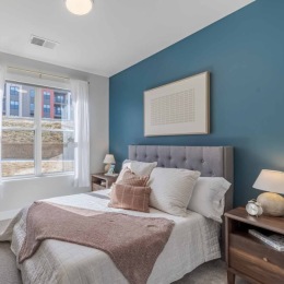 Experience serenity so profound you'll feel it even when you're sleeping sound. Contact our team to learn how to live life just as you dreamed it at The Rosewater. bedroom with a nightstand and a large window